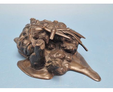 An antique Japanese bronze sculpture of a bamboo basket filled with mud and secured by three stakes on a watery base, silver 