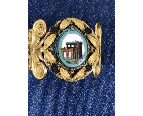 A vintage cuff bangle with painted panel scenes. 