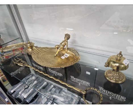 Brass ware: a shell dish with cherub handle, a table bell, a toasting fork, an inkwell, etc.