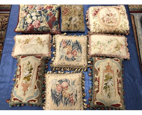 Nine cushions covered in 18th century and later floral tapestry