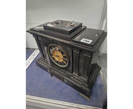 A black slate cased mantel clock striking on a coiled rod
