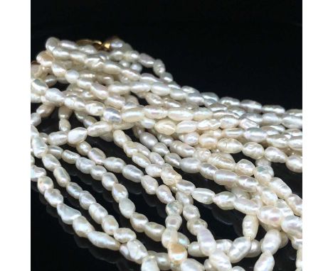 A vintage baroque pearl suite, comprising of a three-strand necklace, bracelet, and a pair of drop earrings. The fittings unh