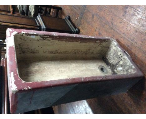 A large sized ceramic Belfast type sink, painted red on the exterior, 25cm x 93cm x 45cm