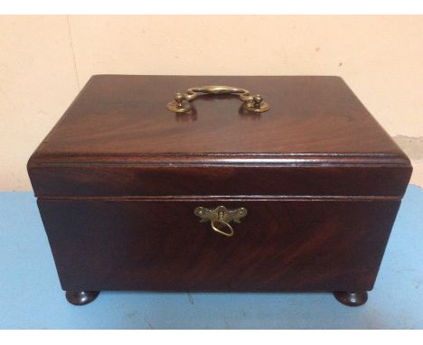 A George III mahogany tea caddy, fitted with four sections with removable dividers, raised on feet