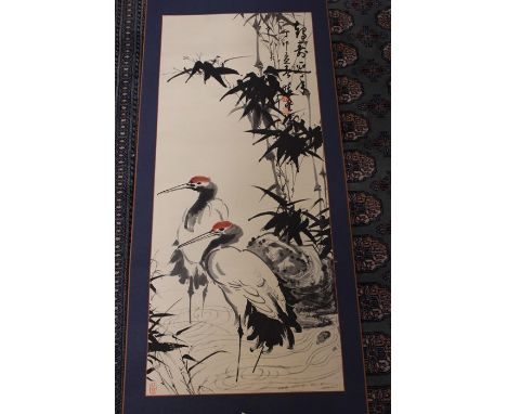 Chinese School 20th century, two red-capped cranes beneath bamboo, ink with red detail, signature and red seal marks