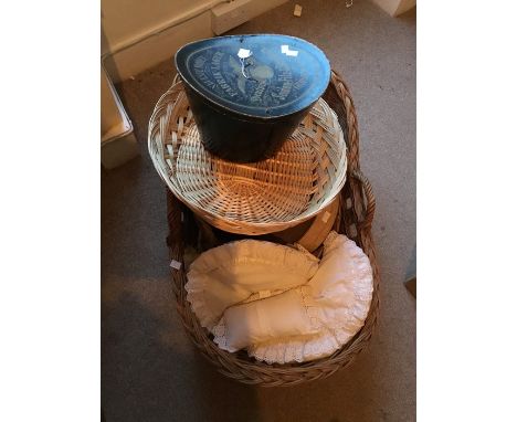 A Moses basket in wicker; a small log basket; a large oval basket used for matinee itms for babies,; a small babies decorated