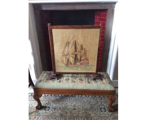 An early 20th Century embroidered firescreen, together with a woolwork footstool (2)