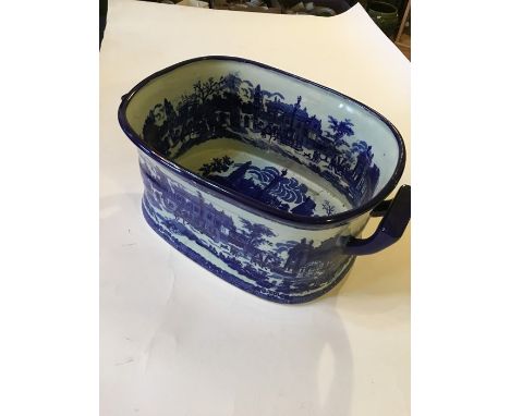 A 20th century ceramic foot bath with blue and white decoration.
