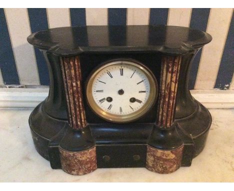 A late 19th Century black slate eight day mantle clock, with panels of inset red marble to front