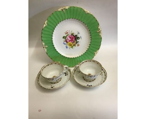 A Royal Crown Derby cabinet plate with a deep fluted border, and gilt and cream raised relief. The centre painted with a flor