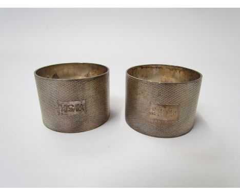 Two Roberts &amp; Dove silver napkin rings both monogrammed with engine turned detailing, Birmingham 1937, 89g