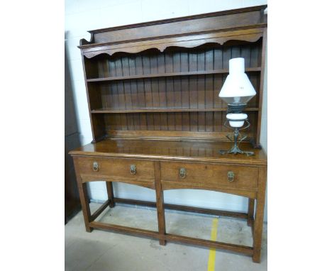 18th/19th Century oak dresser with two tier plate rack, above another ornamental Pot Shelf. Below, two long drawers with lion