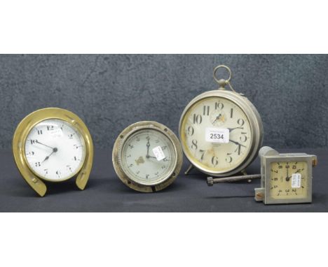 Two old Smiths car clocks; also a small drumhead mantel clock timepiece within a horseshoe surround, 5.25" high and a Westclo