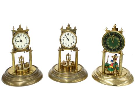 Early German torsion clock, with disc pendulum, under a glass dome and upon a circular stepped brass base, 12" high; also a s