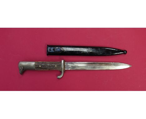 A German dress bayonet with stag grips, maker Albert Kuhl Munster-Essen, 'Helmut' to reverse, black painted steel scabbard. P