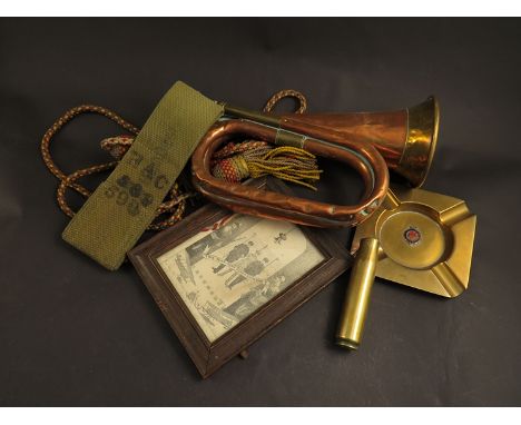 A quantity of military related items including bugle, ashtray and WWI themed print 