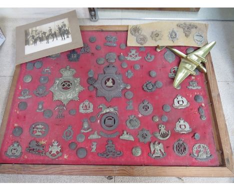 A collection of military badges including Norfolk Regiment helmet example, Suffolk, RA etc