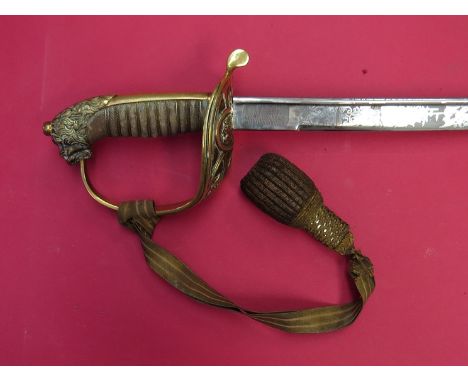 A German naval officer's sword, lion pommel, shagreen grip, guard and engraved blade, leather and brass scabbard