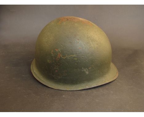 A WWII US Army helmet with original liner, marked 'Dario' and No.56