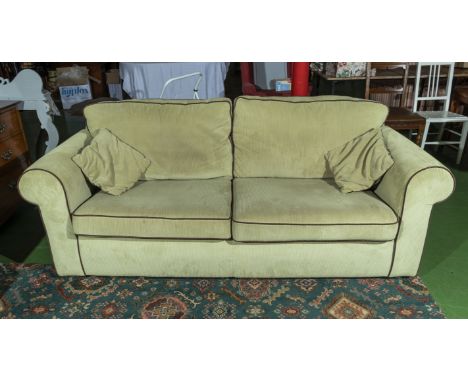 A pale green cord three seater sofa, matching lot 97