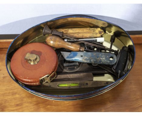A collection of vintage tools, rules and a tape measure