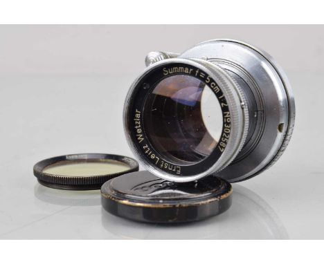 A Leitz Wetzlar Summar 5cm f/2 lens, L39 mount, serial no 302587, 1936, barrel G, elements G, with O filter, front cap, in Le