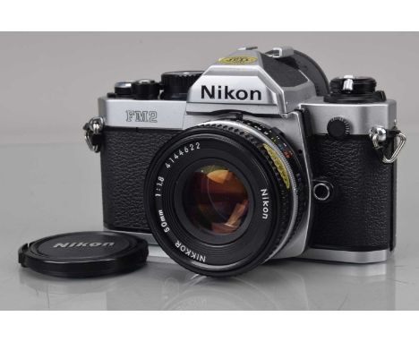 A Nikon FM2n SLR Camera, serial no N 7661536, shutter working, meter responsive, self timer working, body G-VG, with Nikkor 5