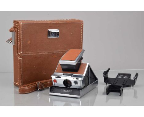 A Polaroid SX-70 Land Camera, tan, untested, body G-VG, elements G-VG, with tripod mount, 132 self timer, 112 remote shutter 