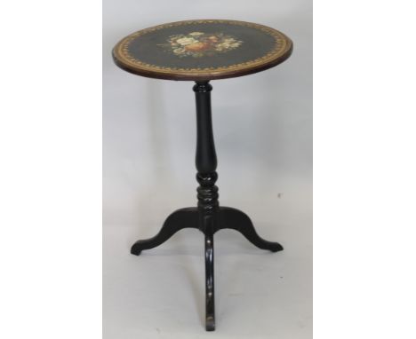 A Victorian mahogany tilt top table, the circular top decorated with flowers within gilt borders, on a turned column and trip