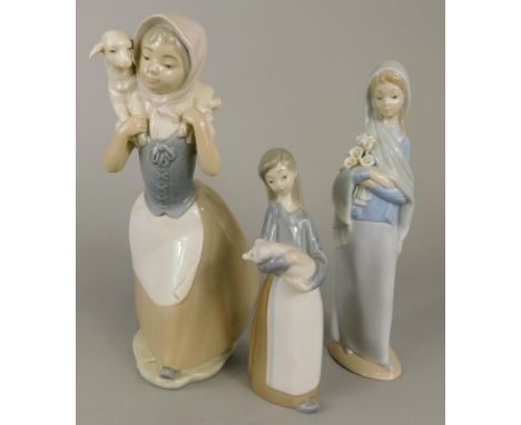 Two Lladro figures of young girls, one with lilies, the other a puppy, together with a Nao figure of a girl with lamb (3)