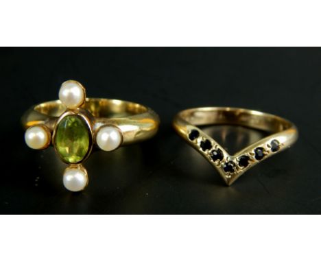 Two 9ct gold dress rings, to include one set with peridot and seed pearl, other in wishbone style set with red stones, 8g all