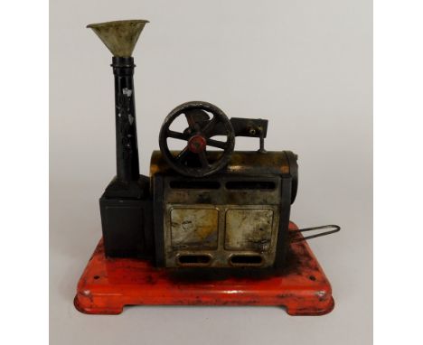 A Mamod paraffin driven static engine, on a red coloured base, 20cm wide.