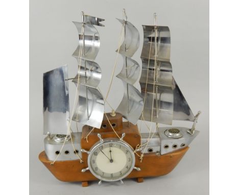 An unusual 1960-70's table lamp, modelled in the form of a three masted sailing ship, centred with a clock with a chrome plat