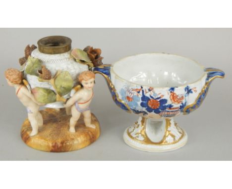 Two items of 19thC porcelain, an early Mason's Imari coloured two handled sauce tureen, lacking lid and a Sitzendorf oil lamp