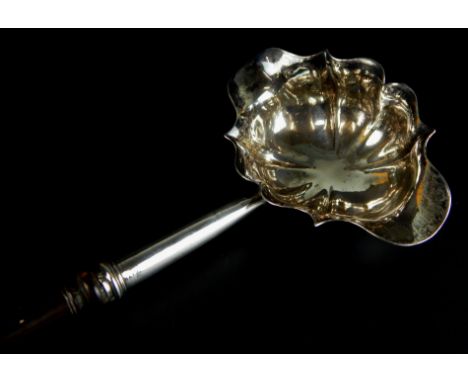 A George II double lipped silver ladle, with an associated turned lignum handle, London 1750