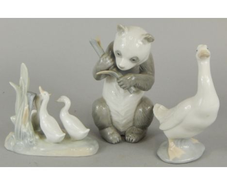 Three Nao porcelain figures, one modelled in the form of a panda eating bamboo shoots