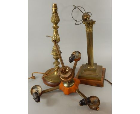 An early 20thC embossed brass table lamp, with wooden base, a similar column lamp and an Art Deco style three branch chandeli