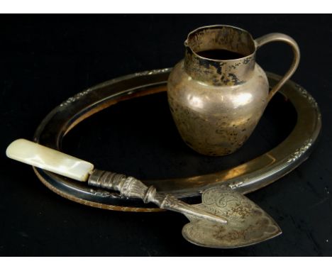 A collection of small silver and silver mounted items, to include an oval photograph frame, a preserve spoon with mother of p