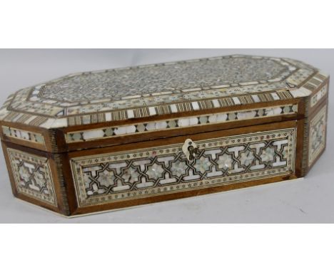 An early 20thC Eastern mother of pearl mosaic style canted rectangular jewellery box, with pierced key, etc, (AF), 36cm wide.