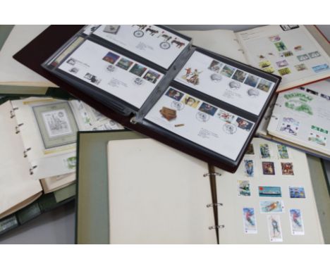A large quantity of first day covers, stamps in three albums, etc.