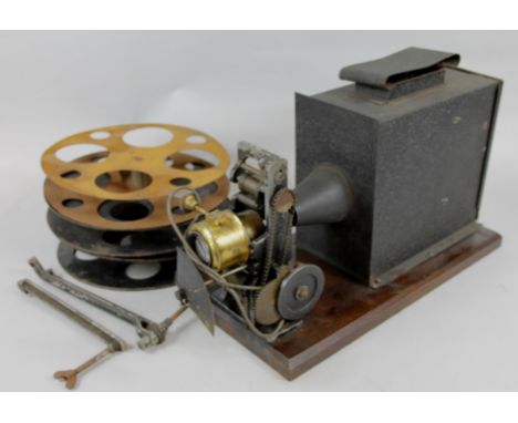 An early hand crank film projector, with various spools, etc., .