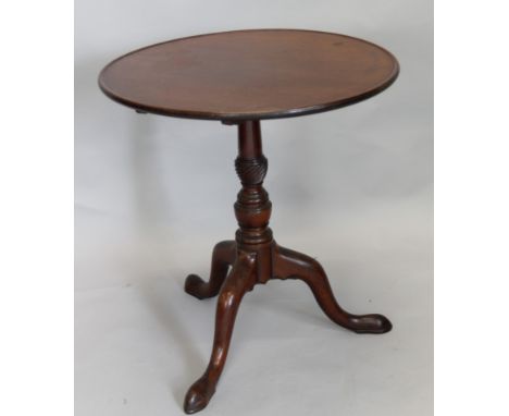 A 19thC mahogany tilt top table, the circular dish top on a turned column, with tripod base, the top 67cm diameter.