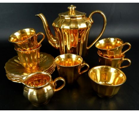 A Wade tea service, in gold lustre design, comprising of five cups and saucers, milk jug, sugar bowl and teapot.