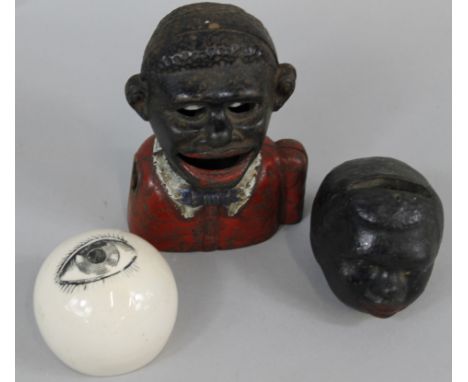 Various collectables, to include a cast iron money box, a similar ceramic money box and a pottery paperweight printed with an