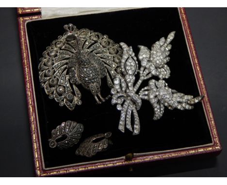 Two vintage costume jewellery brooches, to include a peacock, set with marcasite and red glass eye, with associated earrings 