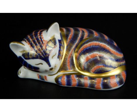 A Royal Crown Derby model of a recumbent cat, painted in the Imari colours, silver button to underside.