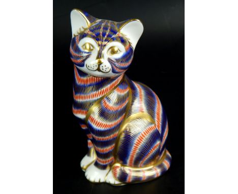A Royal Crown Derby porcelain model of a cat, decorated in Imari colours, gold button to underside.