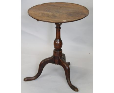 A 19thC oak and elm occasional table, the circular dish top on a turned column and tripod base, (AF), 56cm diameter.