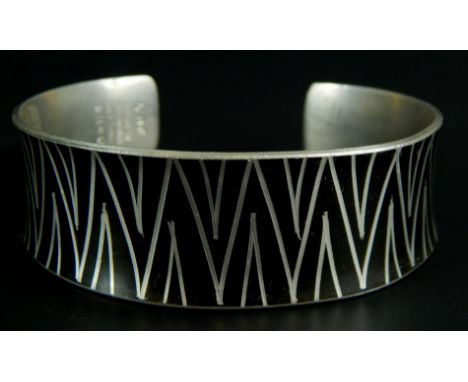 A Danish Jangen Jensen bangle, with black enamel, and triangle type design, pewter, 35.5g all in. 