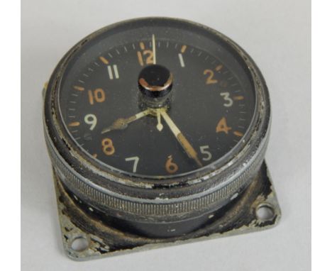 A Vintage aviation clock, in blackened case, indistinctly stamped to reverse, 6.5cm diameter.